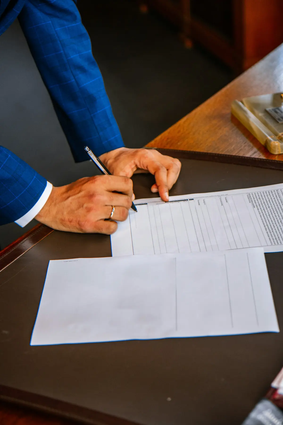 Hand signing a document in ink